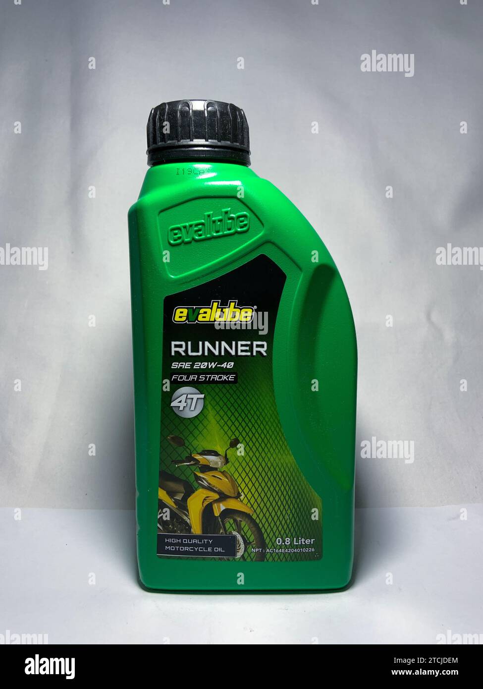 Surakarta, Indonesia - November 20, 2023 : Evalube Runner motor oil, high quality motorcycle oil four stroke 4T 800ml. Evalube green bottle packaging. Stock Photo