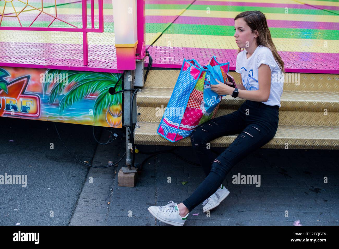 Tilburg, Netherlands. Teenage girl waiting at a annual fair's attraction just before opening. Stock Photo