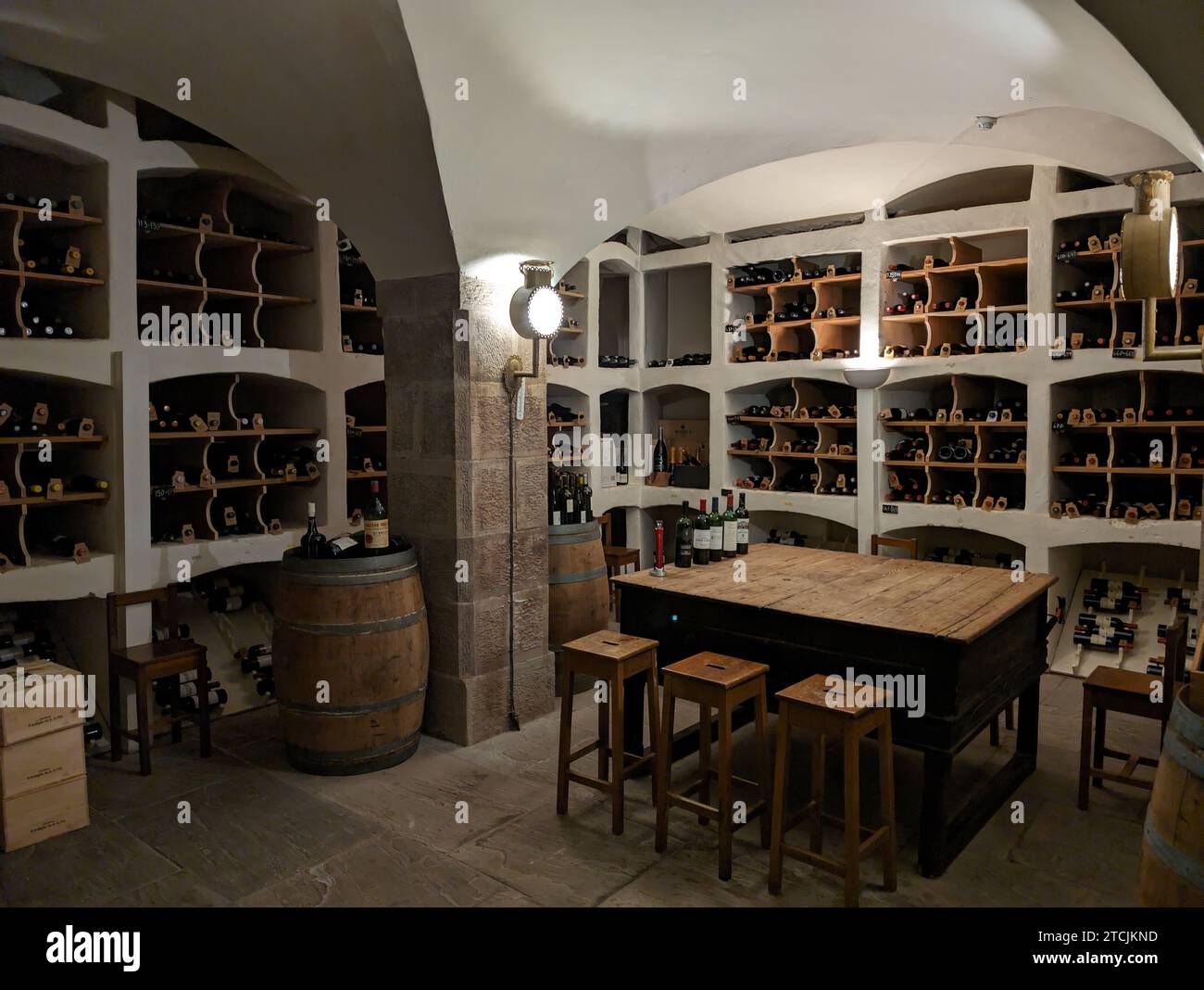 A classic vaulted wine cellar full of fine European wines Stock Photo
