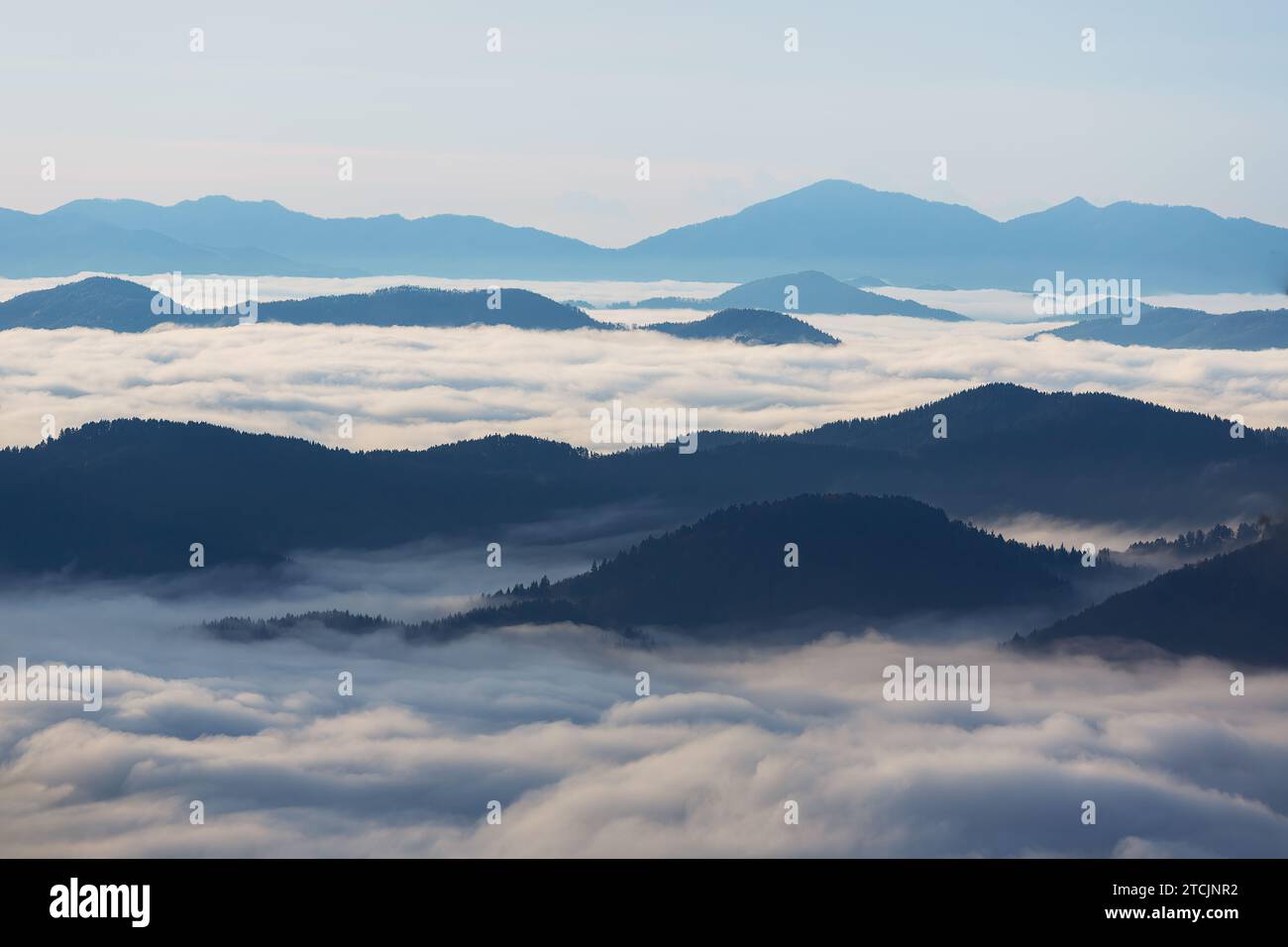 Sunrise over the mountain peaks with fog and clouds Stock Photo - Alamy
