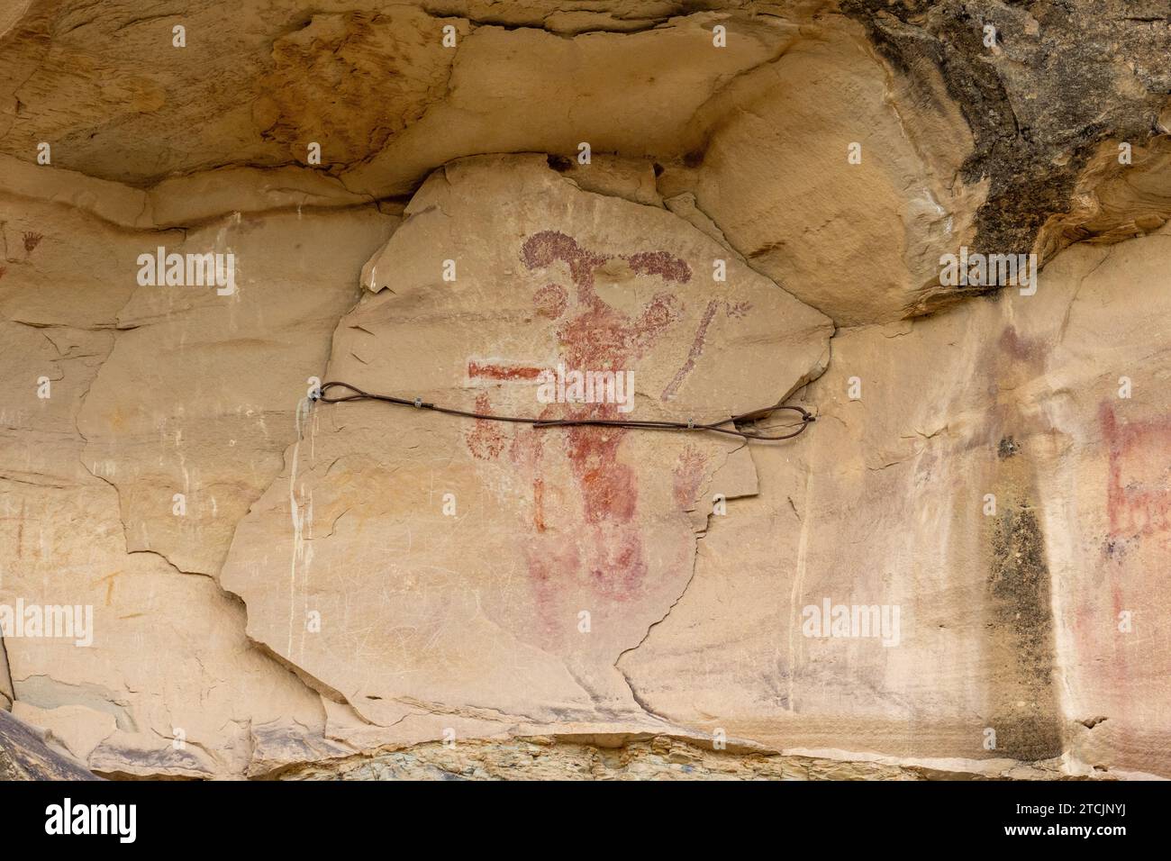 Pre-Hispanic pictographs at the Kokopelli Interpretive Site in the Canyon Pintado National Historic District in Colorado.  Note the stabilization cabl Stock Photo
