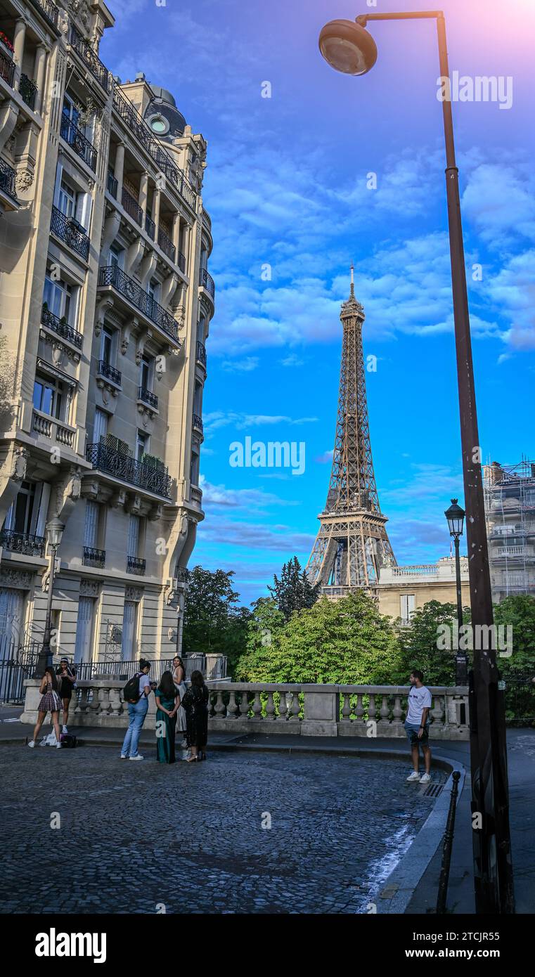 Paris, France July 1, 2022. The Eiffel Tower seen from one of the most sought after points: the Avenue de Camoens. People busy taking photos, beautifu Stock Photo