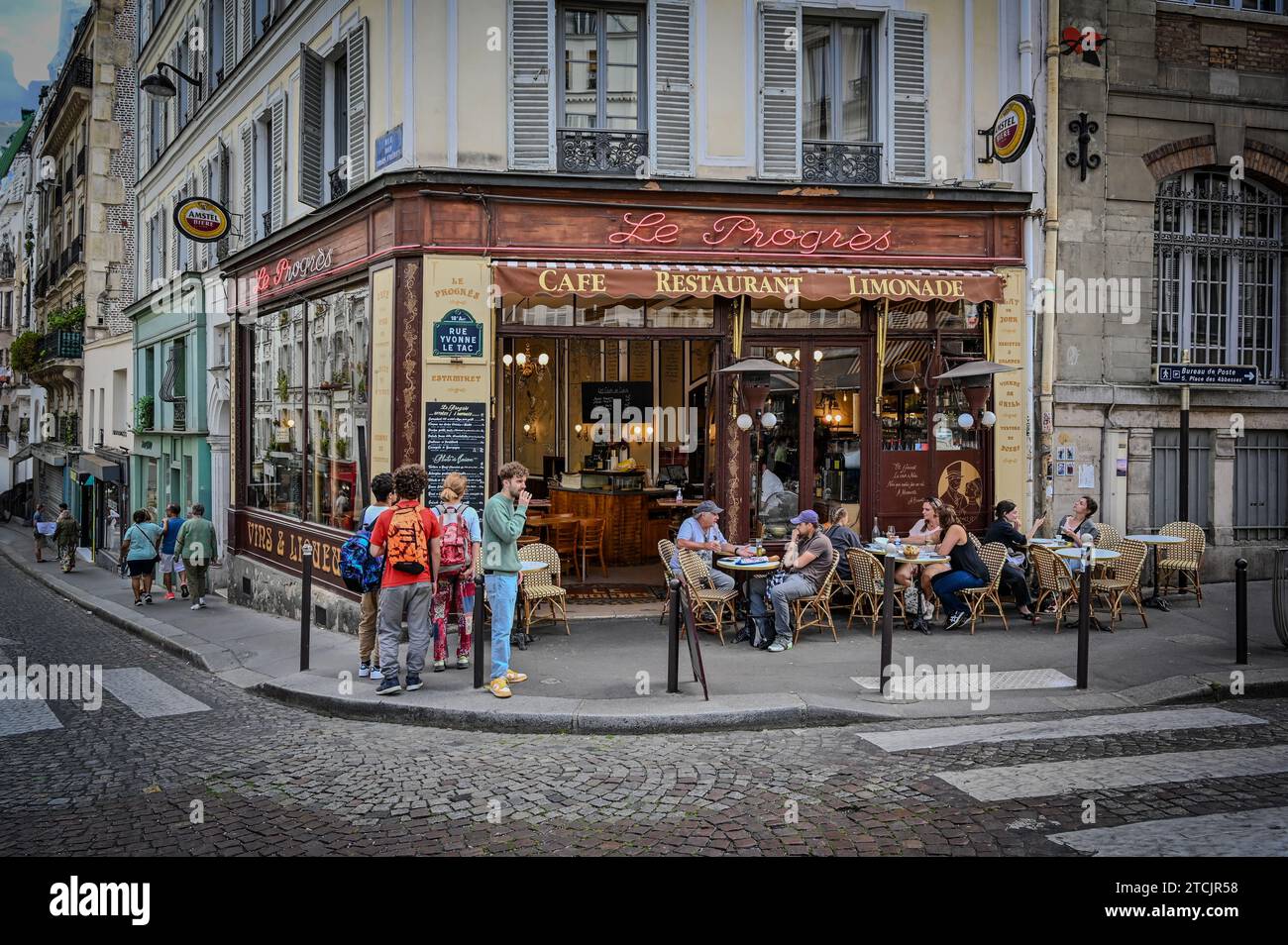 Paris, France July 1, 2022. Le Progres cafe is a traditional French cafe in the Montmartre neighborhood. Full of Parisian charm, people stop in front, Stock Photo