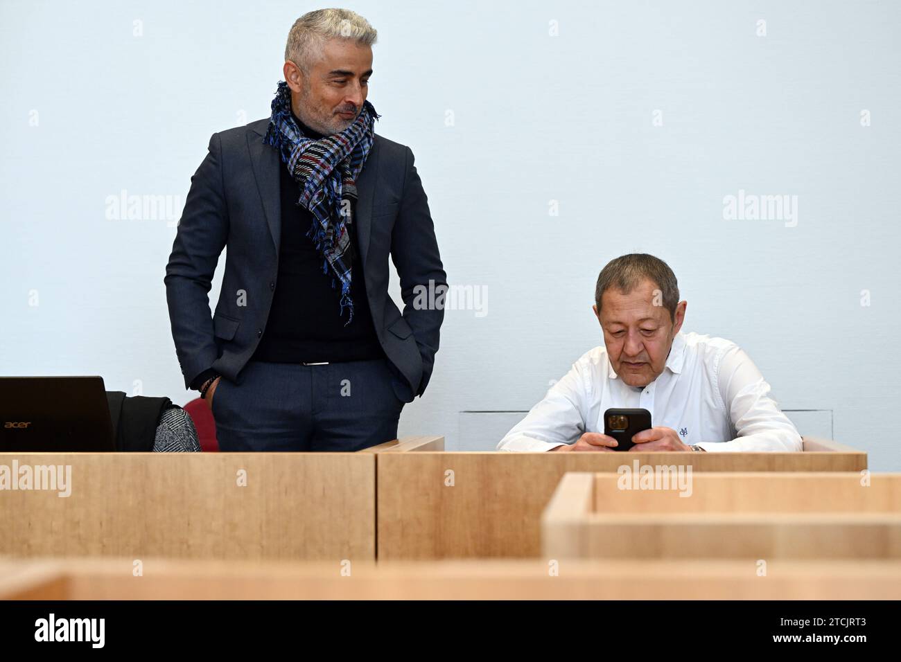 13 December 2023, North Rhine-Westphalia, Bonn: Author and blogger Akif Pirincci (r) and his lawyer Mustafa Kaplan wait in the courtroom of the district court for the trial to begin. Pirinçci is on trial for a blog entry in which he makes hostile remarks about immigrants. He is accused of incitement to hatred. Photo: Federico Gambarini/dpa Stock Photo