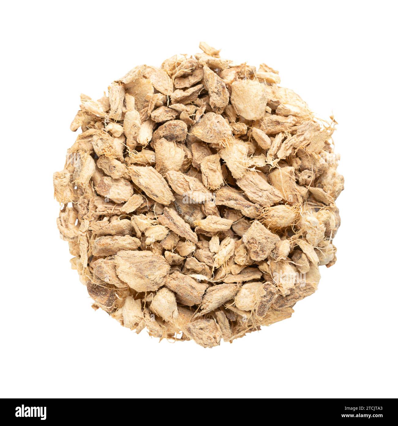 Ginger roots, cut and dried, arranged in a circle. Pieces of dry ginger rhizomes, used as warming spice tea and in traditional folk medicine. Stock Photo