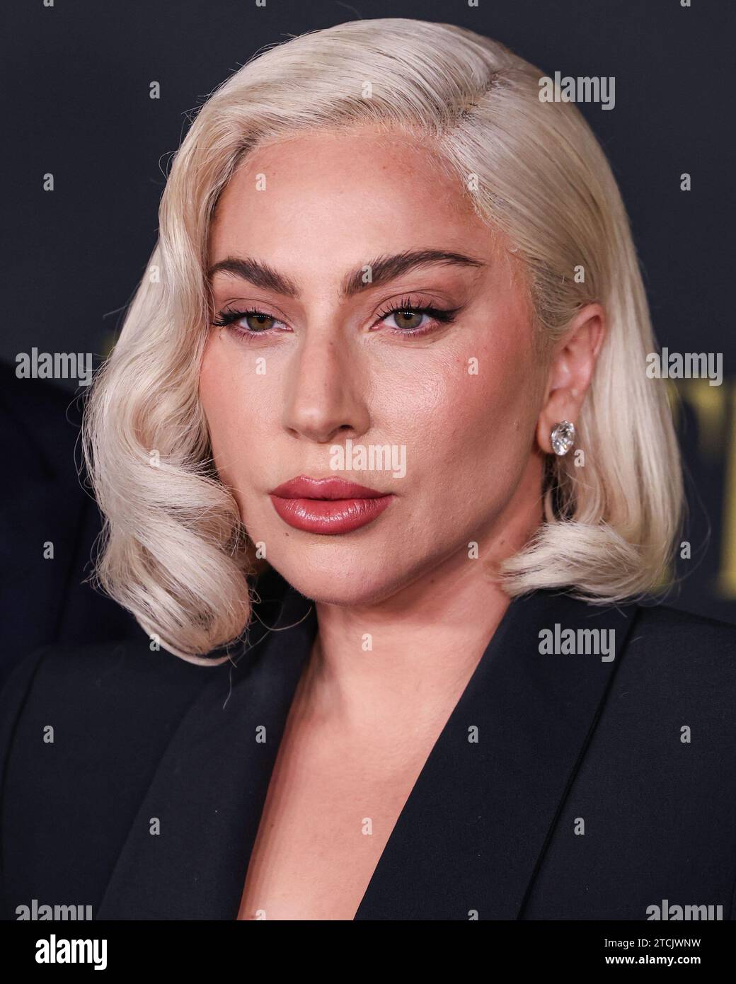 Los Angeles, United States. 12th Dec, 2023. LOS ANGELES, CALIFORNIA, USA - DECEMBER 12: American singer, songwriter and actress Lady Gaga (Stefani Joanne Angelina Germanotta) wearing an Alexander McQueen suit arrives at the Los Angeles Special Screening Of Netflix's 'Maestro' held at the Academy Museum of Motion Pictures on December 12, 2023 in Los Angeles, California, United States. (Photo by Xavier Collin/Image Press Agency) Credit: Image Press Agency/Alamy Live News Stock Photo