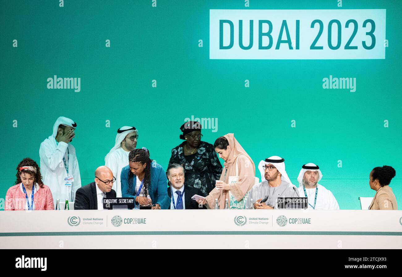 Dubai, United Arab Emirates. 13th Dec, 2023. Sultan al-Jaber (3rd from right), President of COP28, (M), Majid Al Suwaidi (2nd from right), Ambassador and Director-General of COP28, Simon Stiell (3rd from left), Executive Secretary of the United Nations Framework Convention on Climate Change (UNFCCC), and other people wait for the start of the final conference. On Wednesday morning, the COP presidency presented a revised final text. Credit: Hannes P. Albert/dpa/Alamy Live News Stock Photo