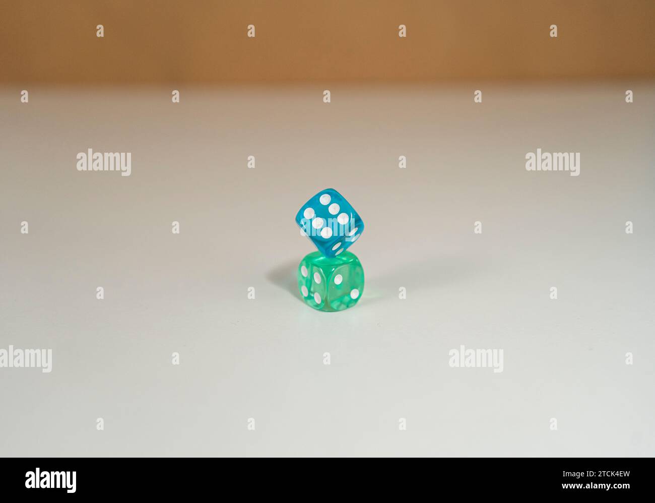 Green and blue dice on top of each other Stock Photo