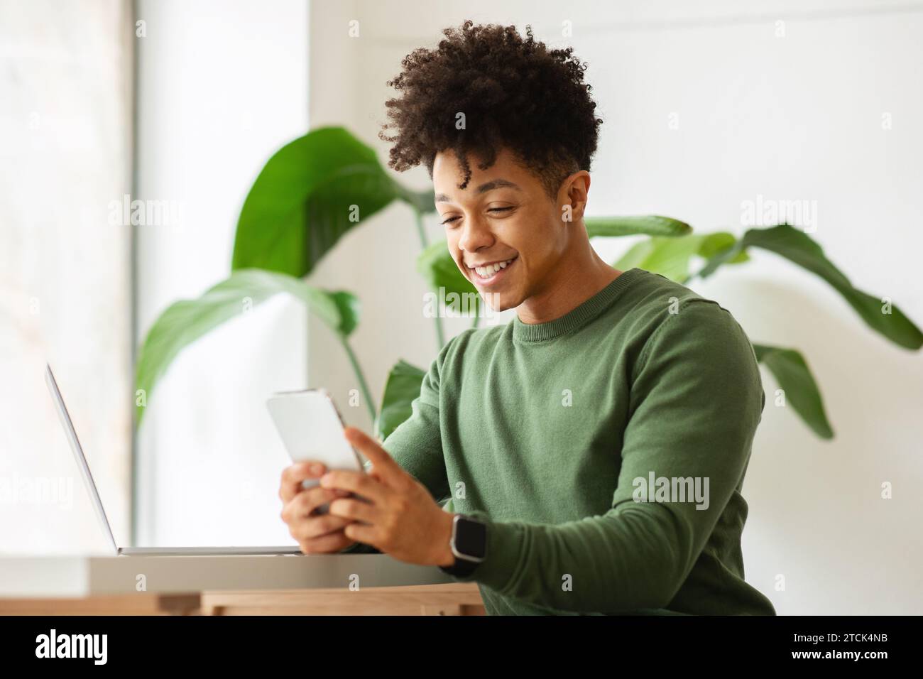 Black guy independent contractor working at cafe, using gadgets Stock Photo