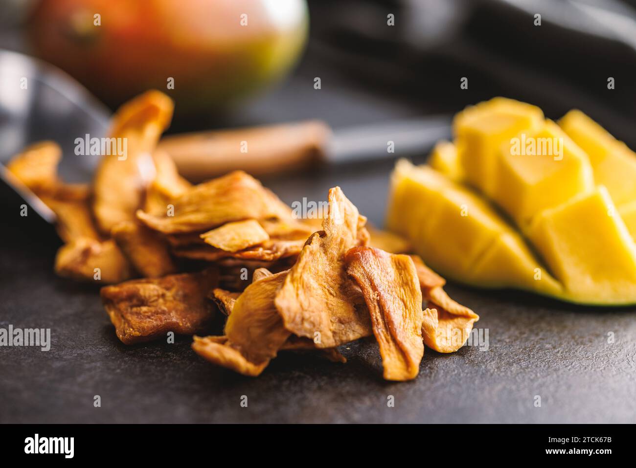 Dried mango fruit on the black table. Stock Photo