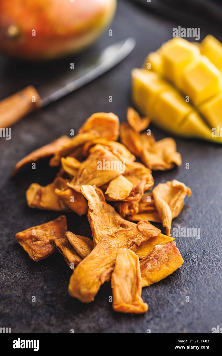 Dried mango fruit on the black table. Stock Photo