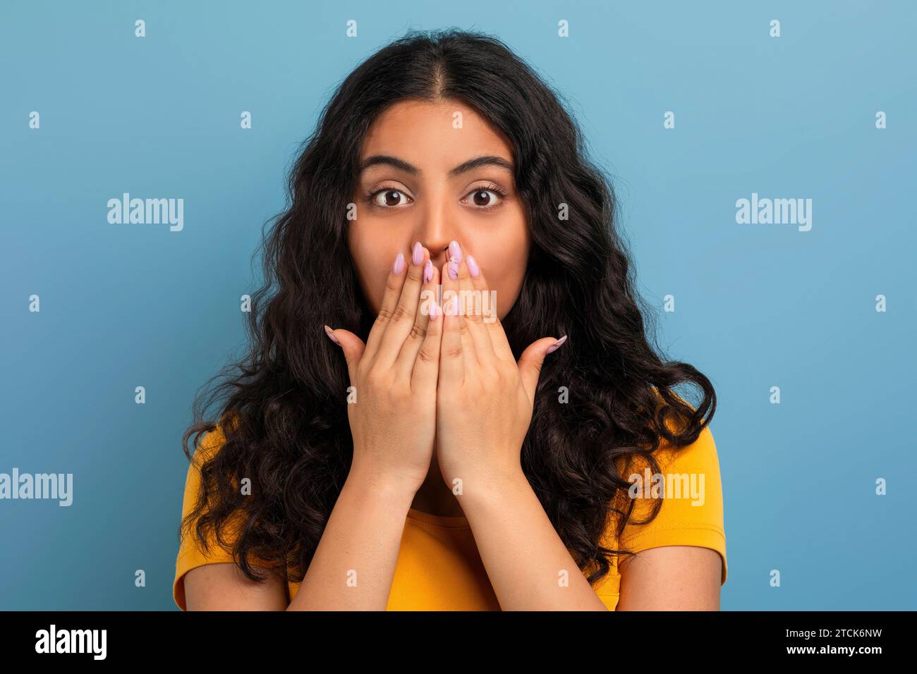 Amazed young eastern woman cover her mouth with hands Stock Photo - Alamy