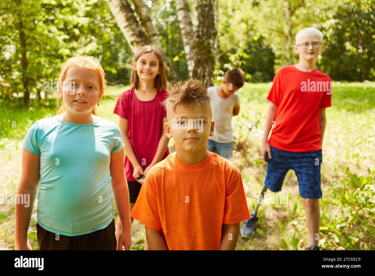 Portrait of boy with male and female friends at park Stock Photo
