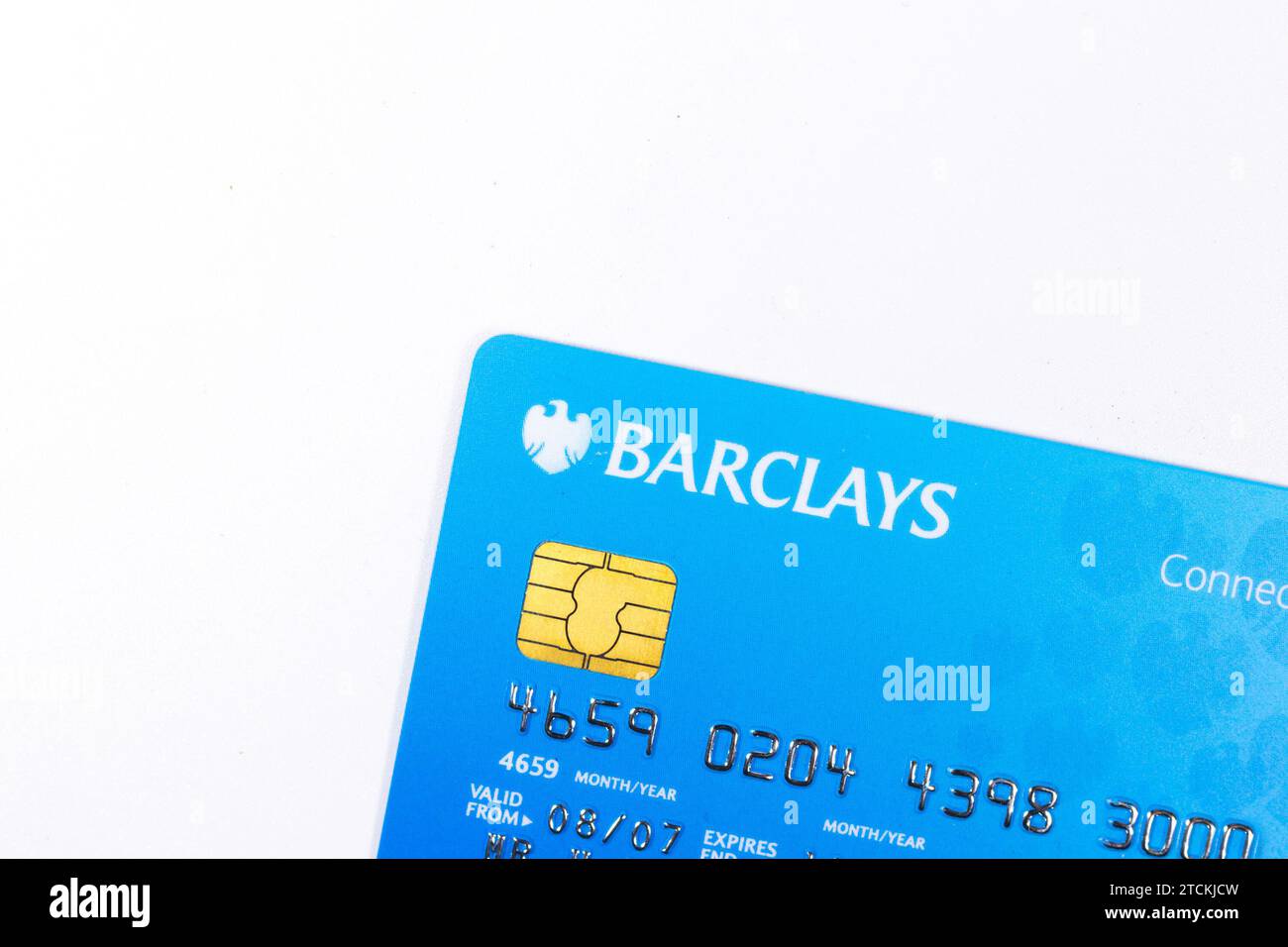 Closeup of a blue Barclays credit card with a visible chip on a white