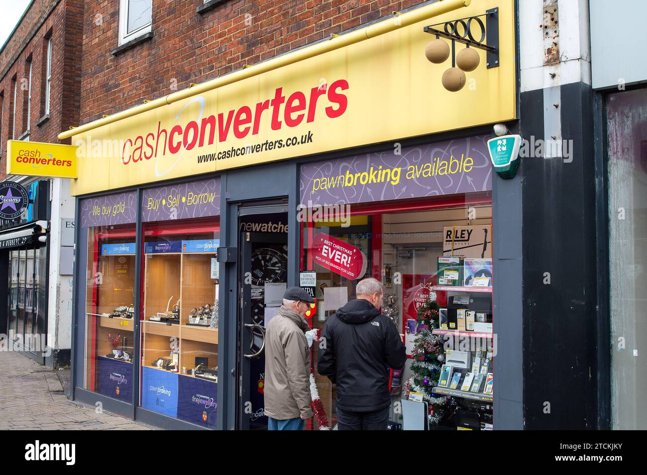 Staines-upon-Thames, UK. 13th December, 2023. Shoppers looking in a CashConvertors Pawn Shop. Shoppers were out in Staines-upon-Thames in Surrey today doing their Christmas Shopping on market day. Credit: Maureen McLean/Alamy Live News Stock Photo