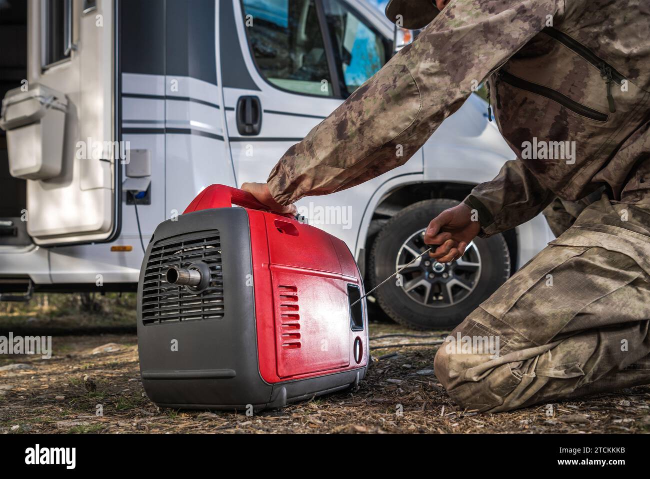 Camper Van RV Owner Preparing Portable Electricity Generator to Hook Up