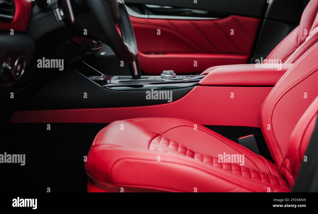 Luxury Red Leather Car Interior Finishing Close Up. Automotive Industry