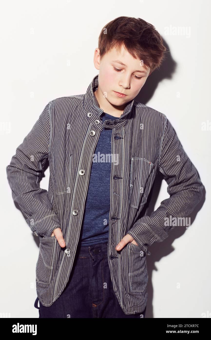 Sad, teenager and insecure boy in studio, white background or thinking ...