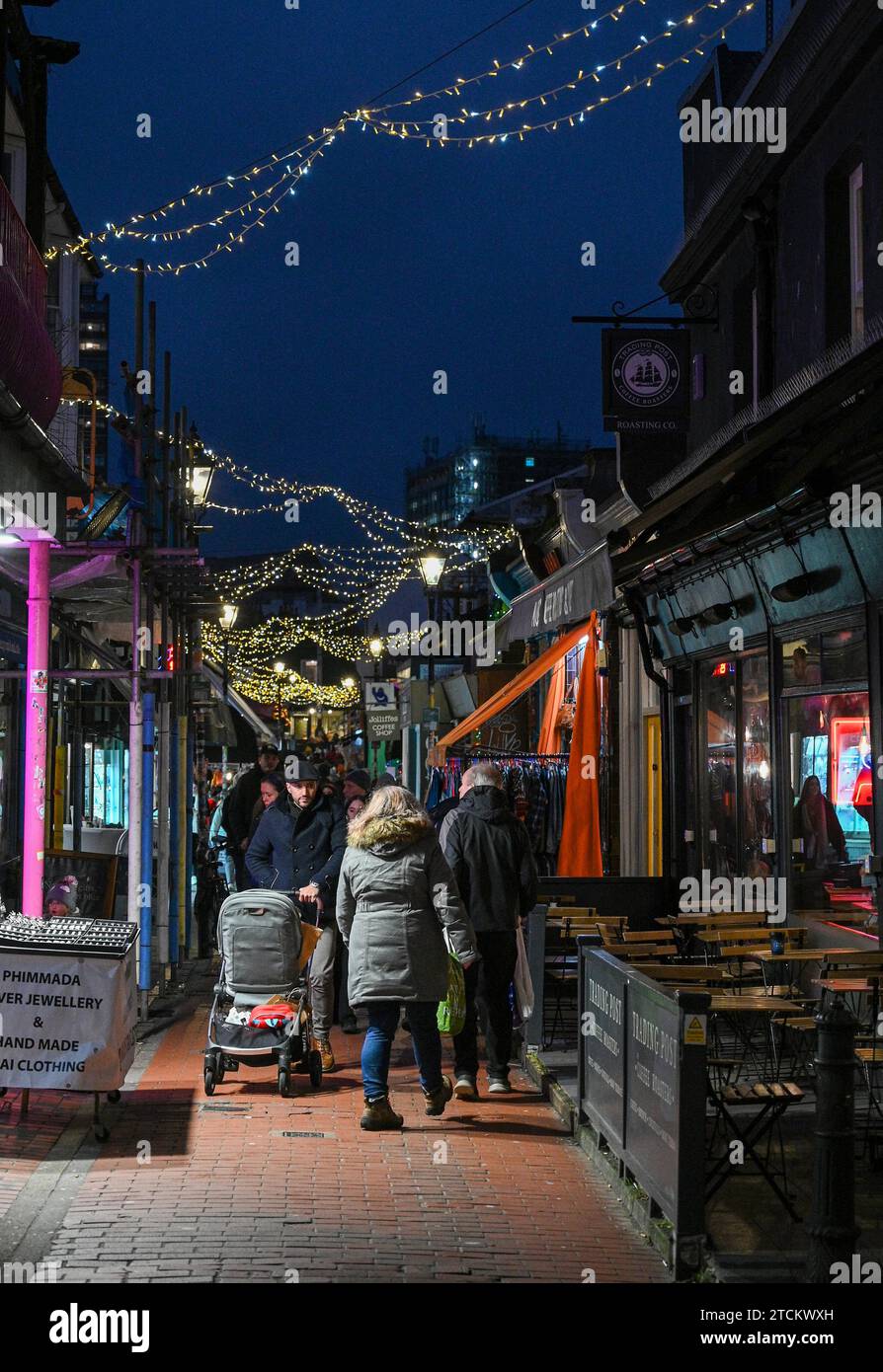 Brighton UK 13th December 2023 - The North Laine area of Brighton is busy with Christmas shoppers as the festive season is in full swing throughout the UK : Credit Simon Dack / Alamy Live News Stock Photo