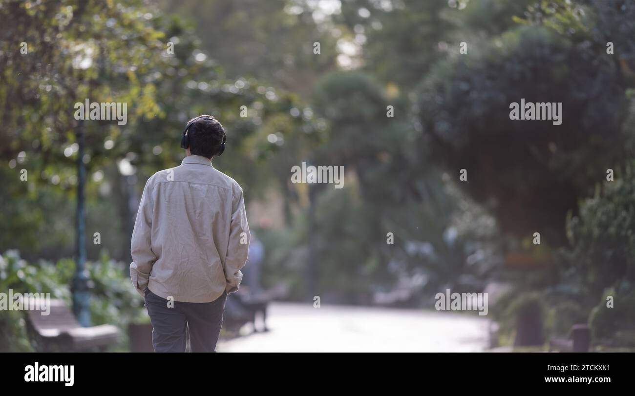 Man in headphones walks hi-res stock photography and images - Alamy