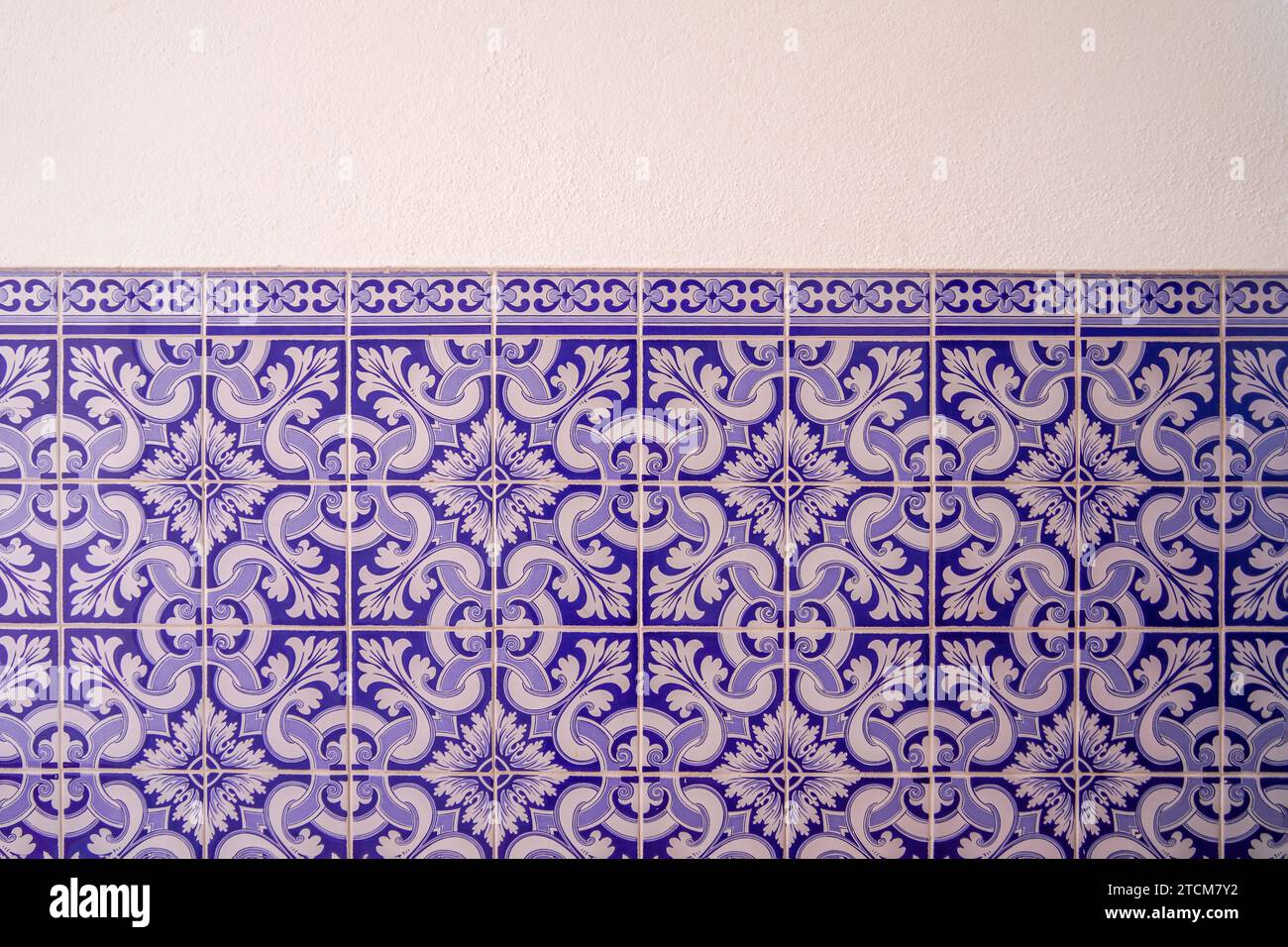 Portuguese Traditional tiles pattern. Retro old vintage wall blue tiles. House Marocain style interior hydraulic ceramic mosaic tiles background. Stock Photo