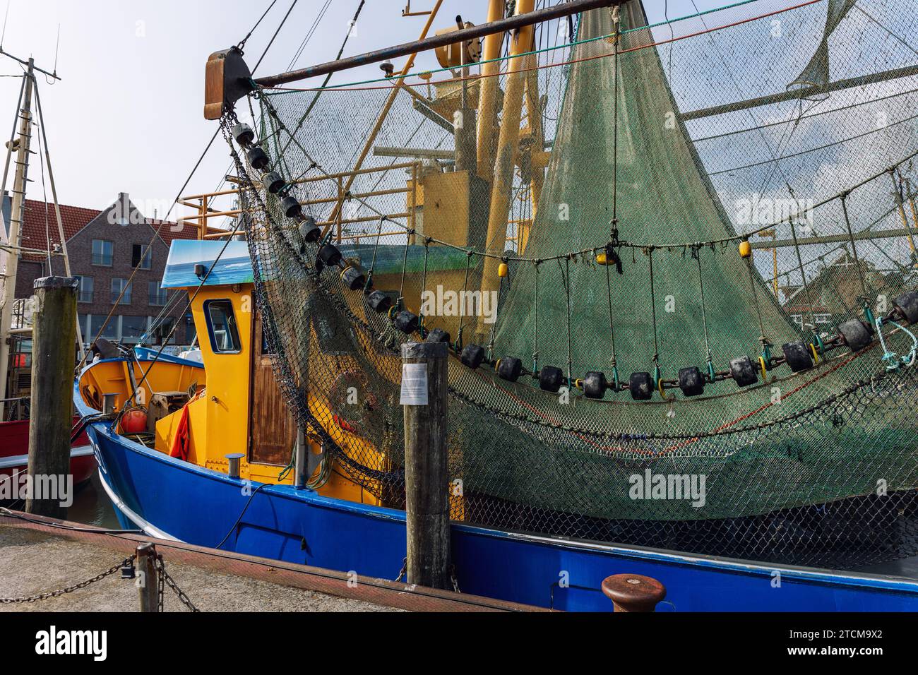 https://c8.alamy.com/comp/2TCM9X2/traditional-old-german-fishing-cutter-boats-moored-neuharlingersiel-harbor-wadden-sea-east-frisia-northern-germany-commercial-fish-crab-shrimp-2TCM9X2.jpg