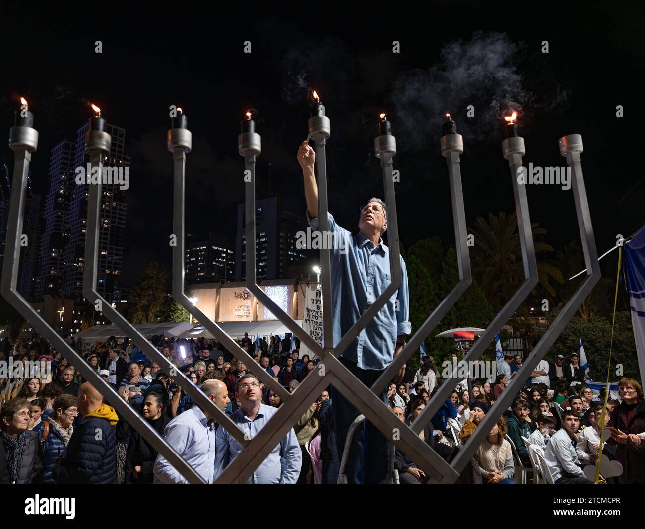 Tel Aviv, Israel. 13th Dec, 2023. A Hanukkiah candelabra is lit with