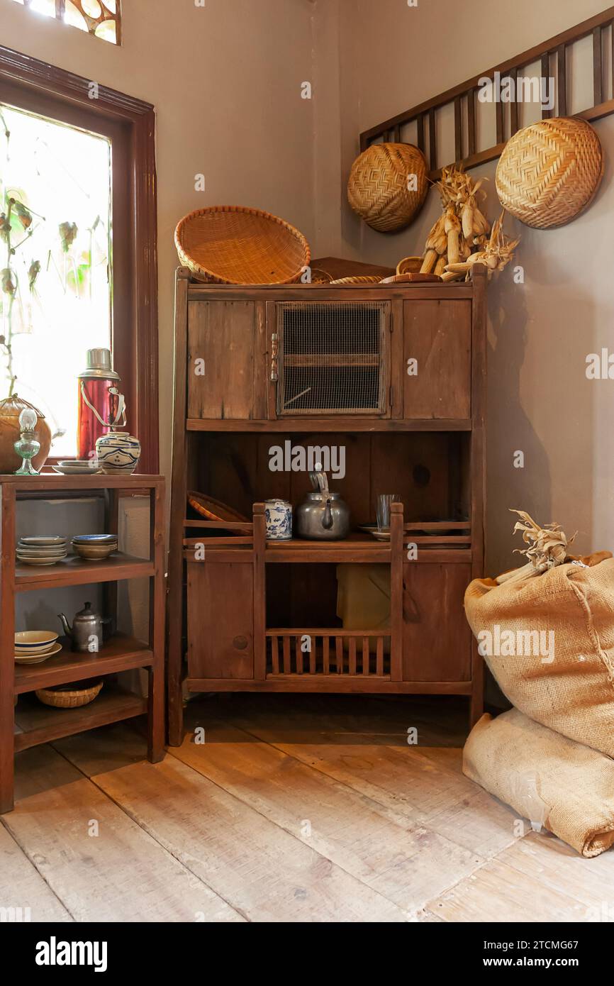 Interior of Vietnamese kitchen with old wooden shelf, ladder