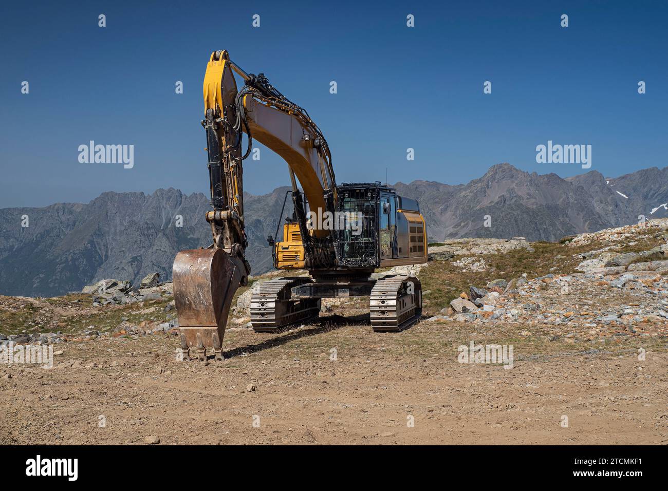 Excavator in the French Alps in summer Stock Photo - Alamy