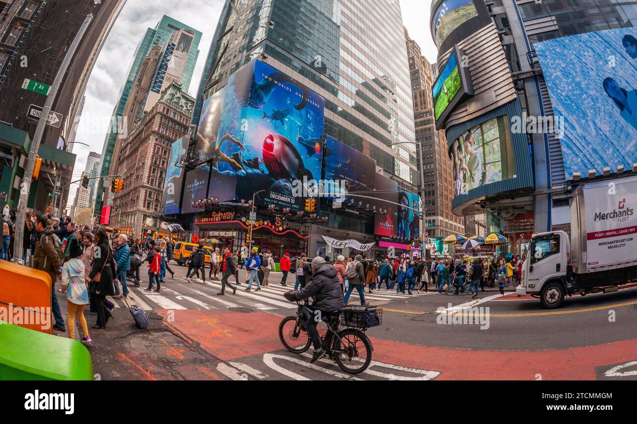 Hordes of people cross West 42nd Street under advertising for the Warner Bros. Pictures’  “Aquaman, The Lost Kingdom” film in Times Square in New York on Saturday, December 2, 2023. The film is slated to be released December 22 and is part of DC Comics’ franchises. (© Richard B. Levine) Stock Photo