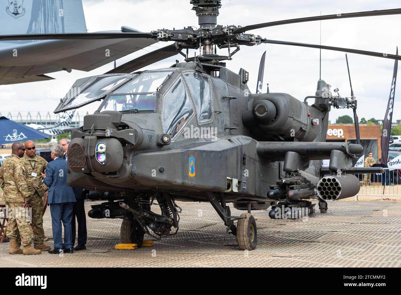 Boeing AH-64 Apache gunship helicopter, weapons & sensors with US personnel and business people at Farnborough International Airshow 2018. Arms trade Stock Photo