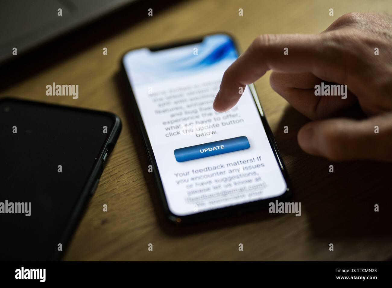Clicking on update button on smartphone app Stock Photo