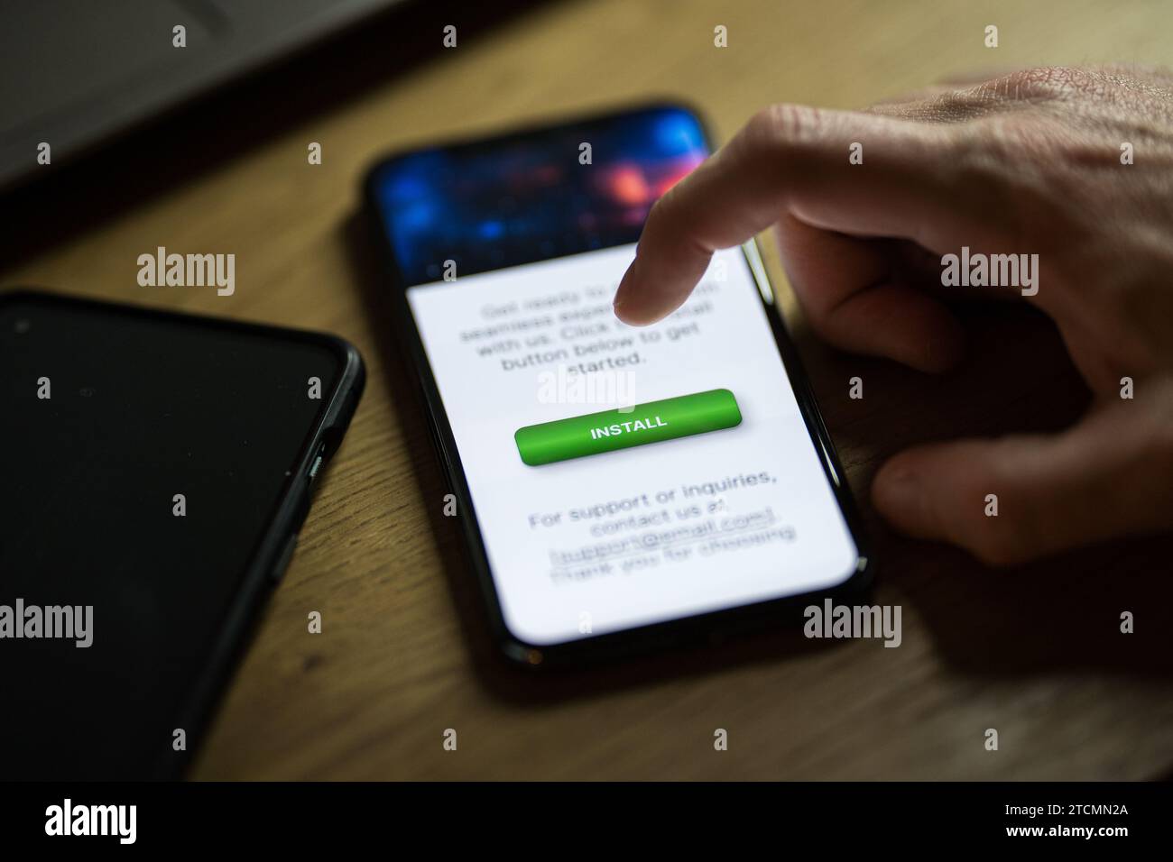 Clicking on green install button on smartphone Stock Photo