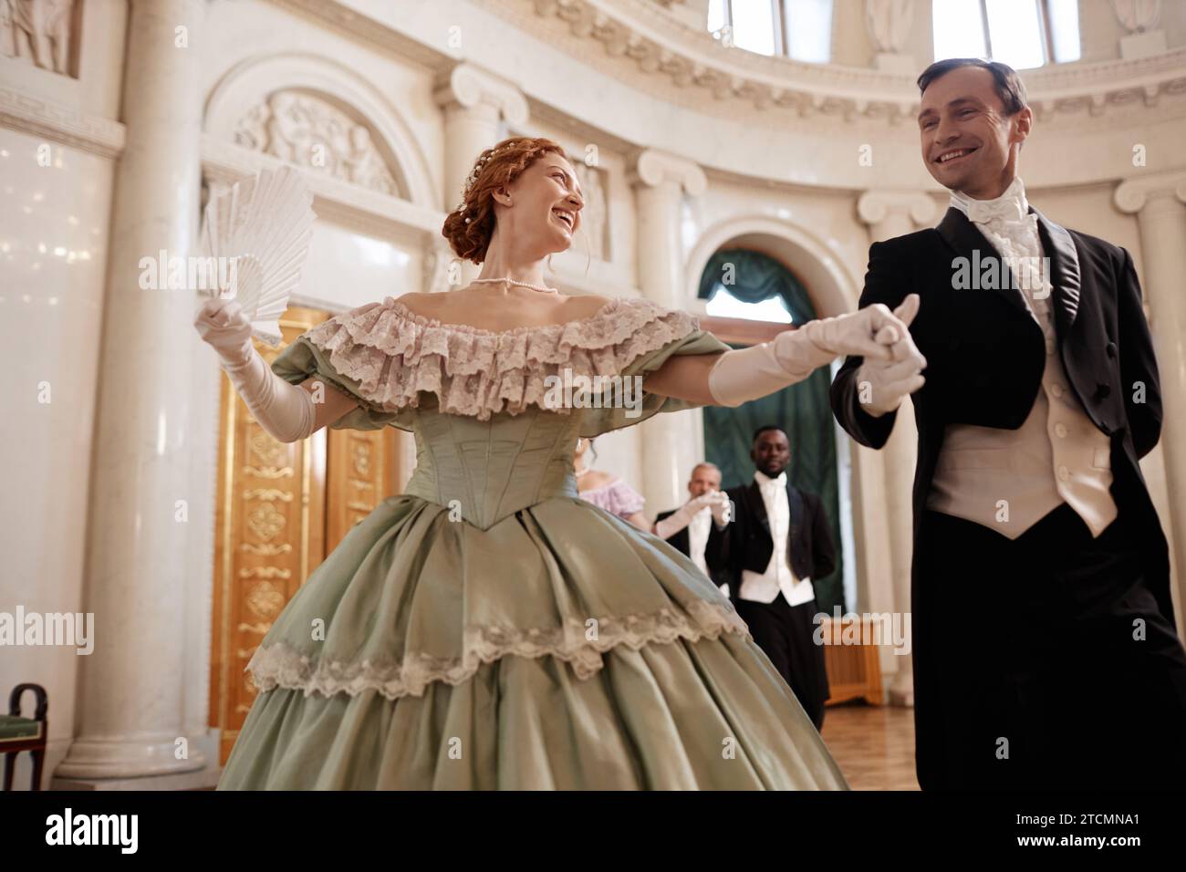 Low angle portrait of beautiful renaissance couple dancing together ...