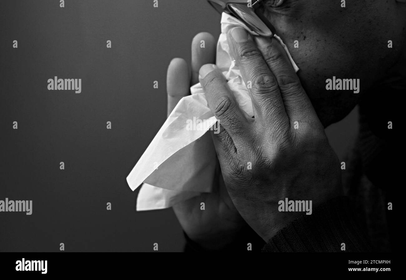 man catching the cold and flu man blowing nose after catching a cold