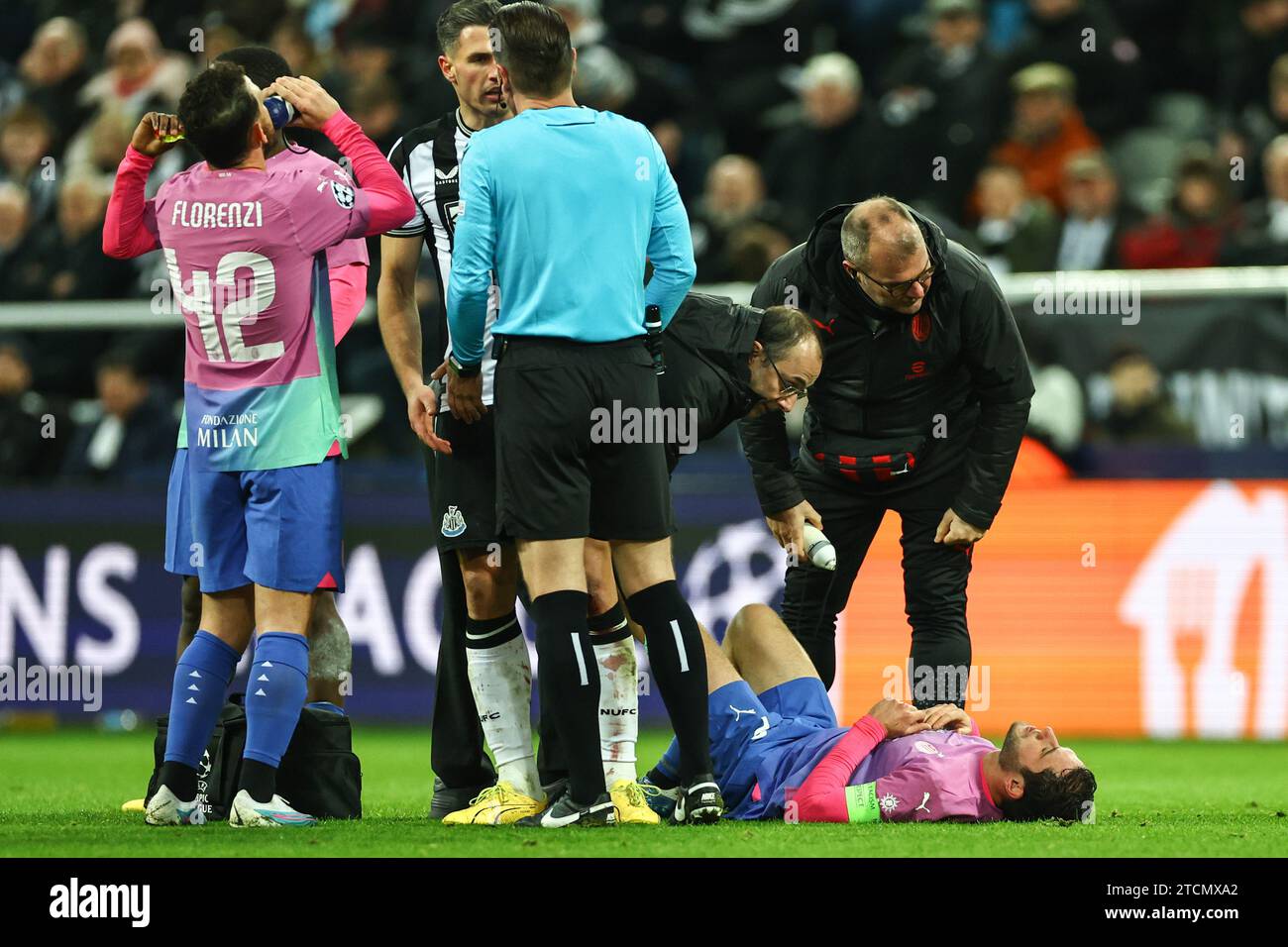 Newcastle, UK. 13th Dec, 2023. Davide Calabria #2 of AC Milan receives treatment during the UEFA Champions League match Newcastle United vs AC Milan at St. James's Park, Newcastle, United Kingdom, 13th December 2023 (Photo by Mark Cosgrove/News Images) Credit: News Images LTD/Alamy Live News Stock Photo