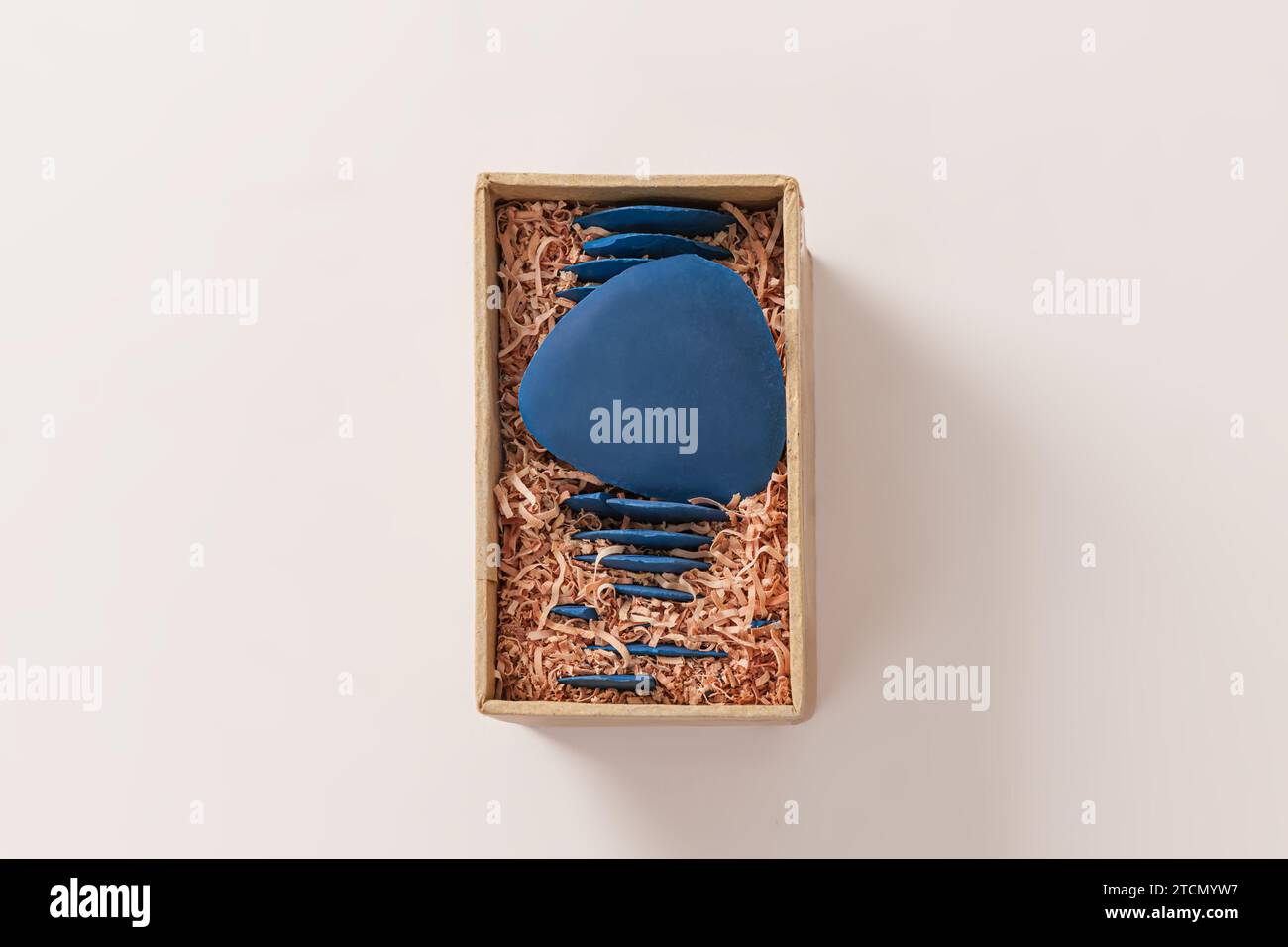 Old blue chalk of tailor in paper box on white background Stock Photo