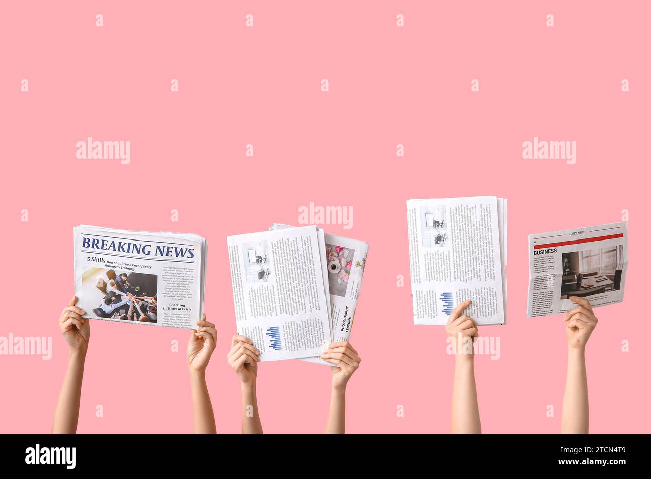 Female hands with different newspapers on pink background Stock Photo