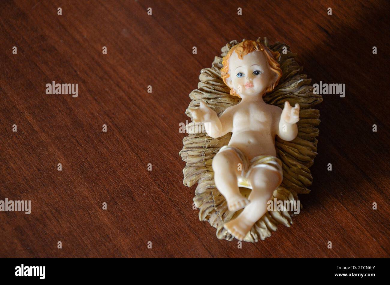 The small image of the Baby Jesus, inside a manger, the expression of