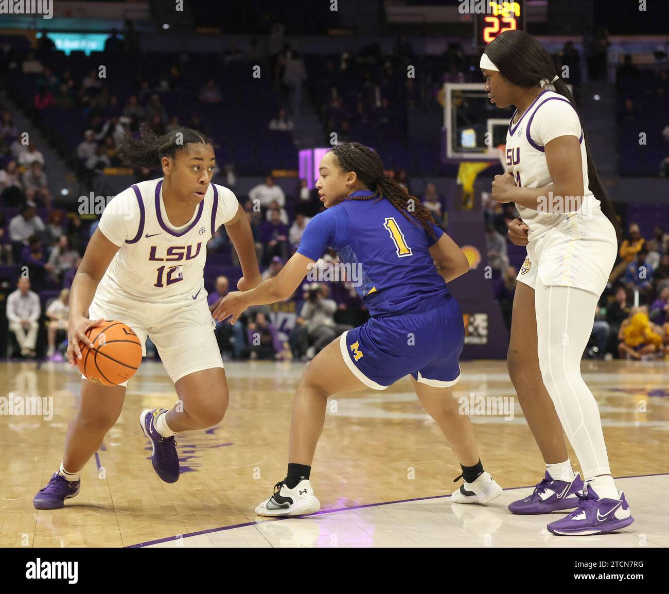Baton Rouge, USA. 12th Dec, 2023. LSU Lady Tigers guard Mikaylah Williams (12) tries to make a crossover dribble against McNeese Cowgirls guard Azjah Reeves (1) while LSU Lady Tigers guard Aneesah Morrow (24) sets up for a pick during a women's college basketball game at Pete Maravich Assembly Center in Baton Rouge, Louisiana on Tuesday, December 12, 2023. (Photo by Peter G. Forest/Sipa USA) Credit: Sipa USA/Alamy Live News Stock Photo