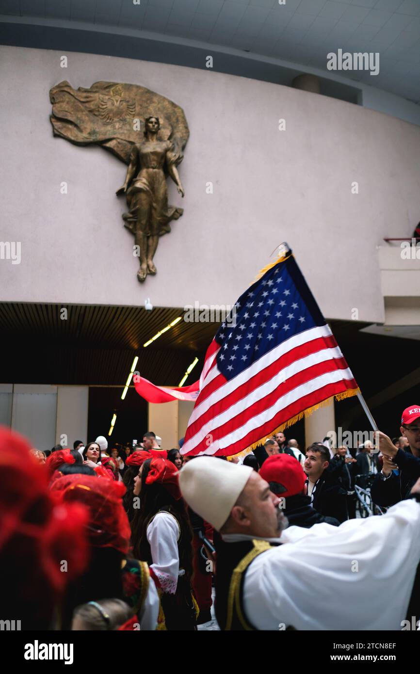 Tirana, Albania - November 28: Traditional Albanian dance with both Albanian and American flags, near the Mother Teresa statue at the Palace Stock Photo