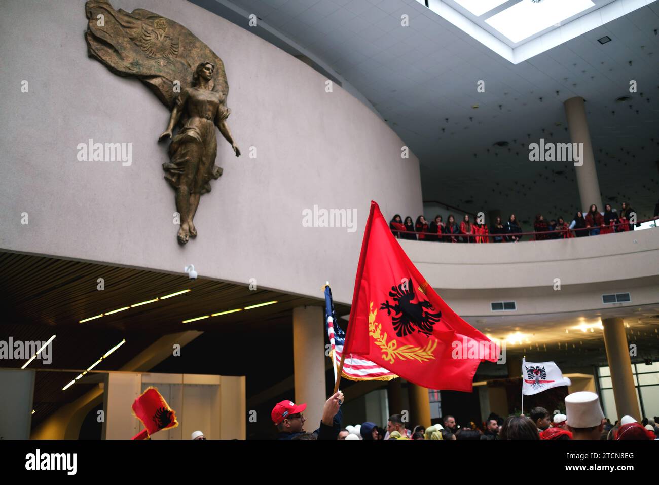 Tirana, Albania - November 28: Traditional Albanian dance with both Albanian and American flags, near the Mother Teresa statue at the Palace Stock Photo