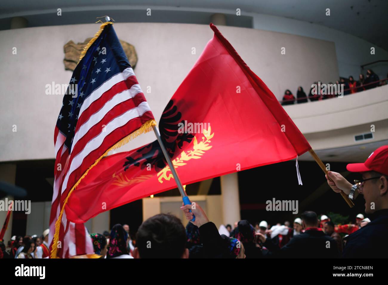 Tirana, Albania - November 28: Traditional Albanian dance with both Albanian and American flags, near the Mother Teresa statue at the Palace Stock Photo