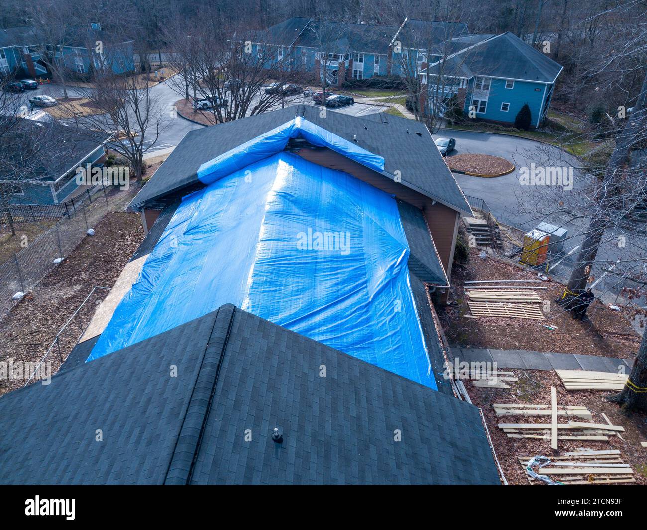 drone images of a fire damaged apartment building with a large tarp