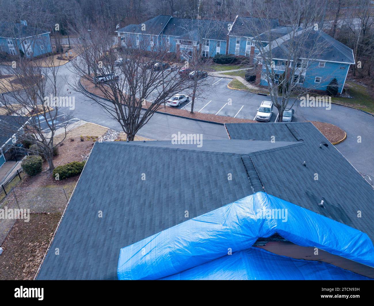 drone images of a fire damaged apartment building with a large tarp