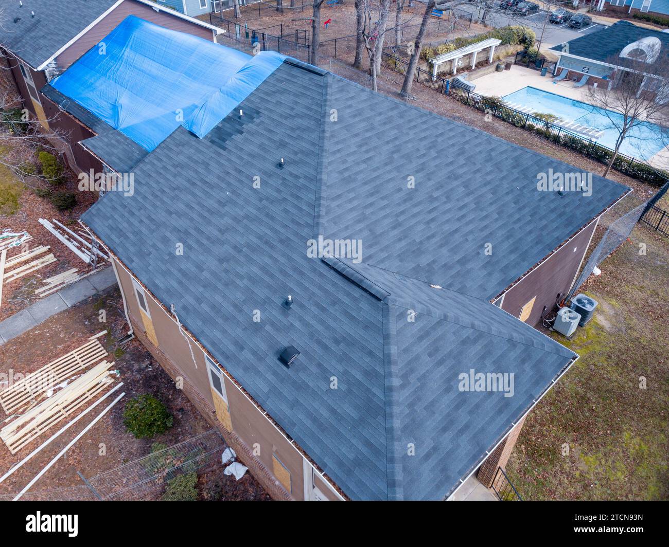 drone images of a fire damaged apartment building with a large tarp