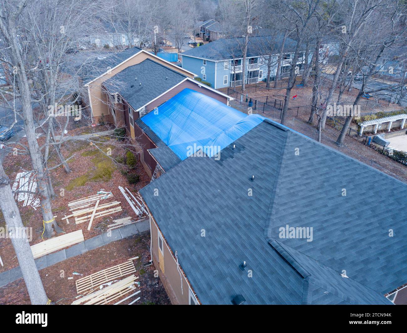 drone images of a fire damaged apartment building with a large tarp