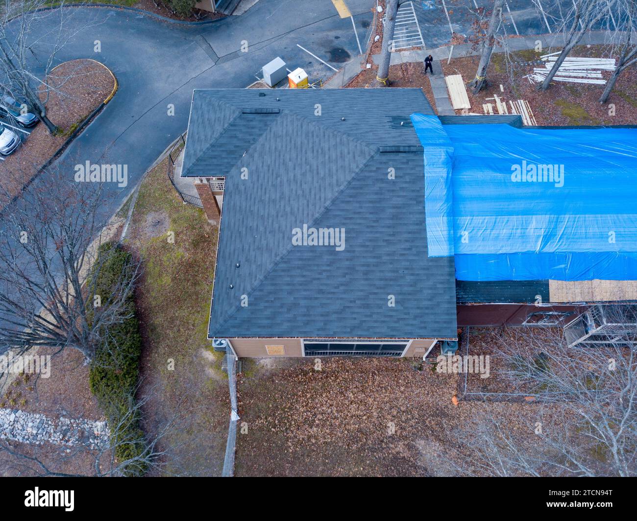 drone images of a fire damaged apartment building with a large tarp