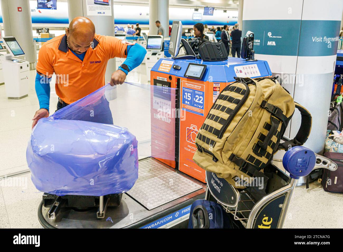 Miami Florida,Miami International Airport MIA,inside interior indoors,terminal concourse,travelers travellers,safe wrap luggage wrapping service secur Stock Photo
