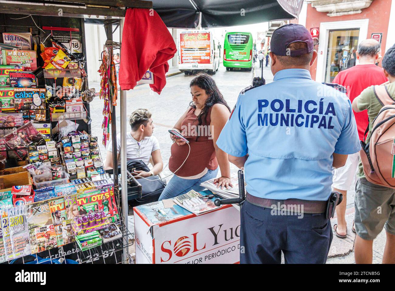 Merida Mexico,centro historico central historic district,municipal city police policeman,newsstand sidewalk vendor,man men male,woman women lady femal Stock Photo